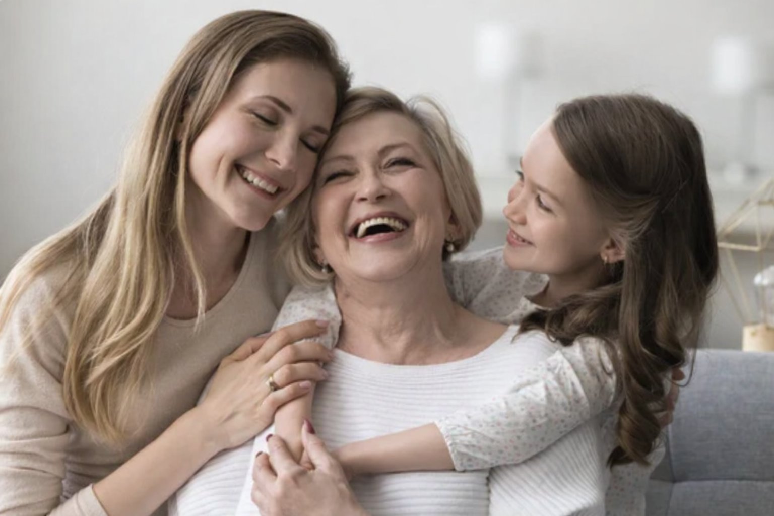 Three generations of women smiling together