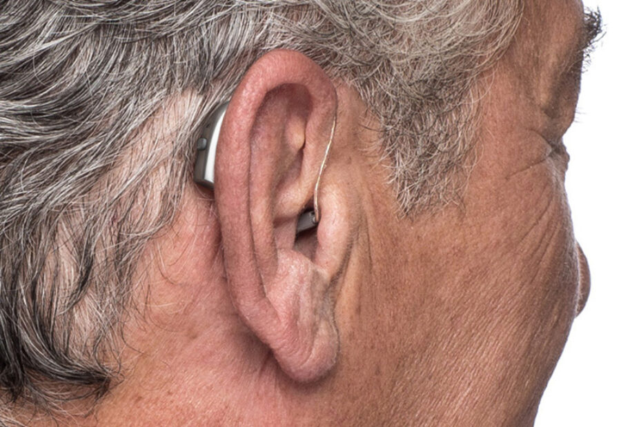 RIC hearing aid worn behind the ear